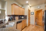 Fully equipped kitchen with gas range, four gas burners, stainless steel appliances